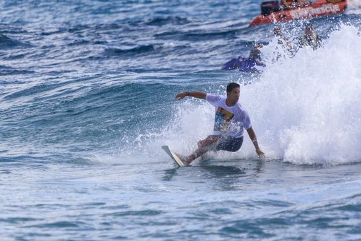 SNAPPER ROCKS, GOLD COAST, AUSTRALIA - 9 MARCH: Unidentified Surfer races the Quiksilver & Roxy Pro World Title Event. 9 March 2013, Snapper Rocks, Gold Coast, Australia