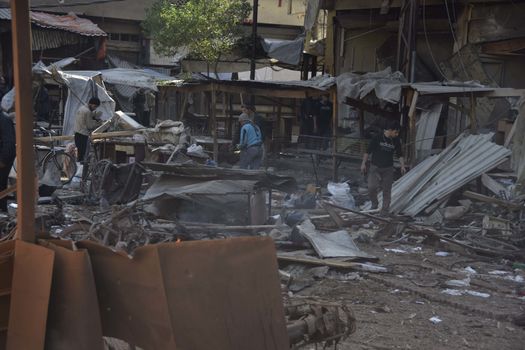 SYRIA, Douma : Residents inspect damage after at least 40 people have been killed and over 100 others wounded after Syrian government air strikes targeted a popular marketplace in Douma, a Damascus suburb on October 30, 2015 as peace talks begin in Vienna.