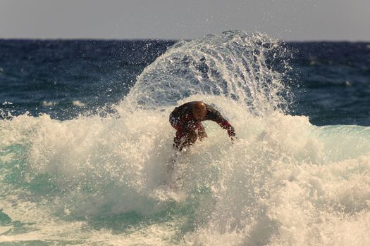 SNAPPER ROCKS, GOLD COAST, AUSTRALIA - 9 MARCH: Unidentified Surfer races the Quiksilver & Roxy Pro World Title Event. 9 March 2013, Snapper Rocks, Gold Coast, Australia