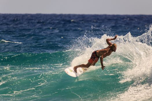 SNAPPER ROCKS, GOLD COAST, AUSTRALIA - 9 MARCH: Unidentified Surfer races the Quiksilver & Roxy Pro World Title Event. 9 March 2013, Snapper Rocks, Gold Coast, Australia