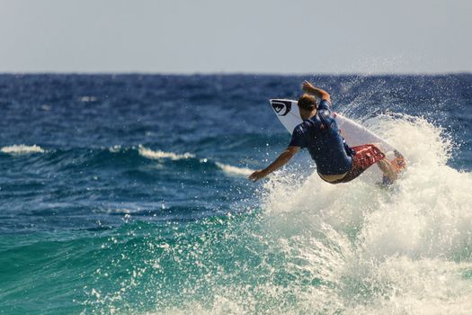 SNAPPER ROCKS, GOLD COAST, AUSTRALIA - 9 MARCH: Unidentified Surfer races the Quiksilver & Roxy Pro World Title Event. 9 March 2013, Snapper Rocks, Gold Coast, Australia