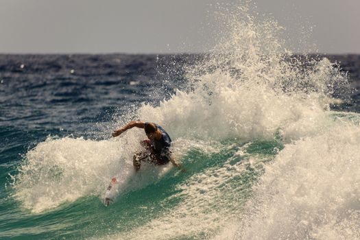 SNAPPER ROCKS, GOLD COAST, AUSTRALIA - 9 MARCH: Unidentified Surfer races the Quiksilver & Roxy Pro World Title Event. 9 March 2013, Snapper Rocks, Gold Coast, Australia