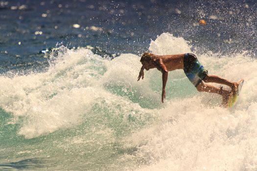 SNAPPER ROCKS, GOLD COAST, AUSTRALIA - 9 MARCH: Unidentified Surfer races the Quiksilver & Roxy Pro World Title Event. 9 March 2013, Snapper Rocks, Gold Coast, Australia