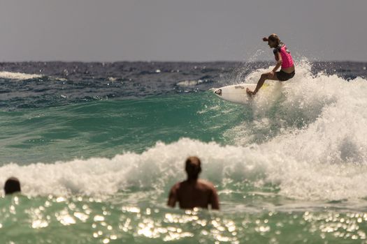 SNAPPER ROCKS, GOLD COAST, AUSTRALIA - 9 MARCH: Unidentified Surfer races the Quiksilver & Roxy Pro World Title Event. 9 March 2013, Snapper Rocks, Gold Coast, Australia