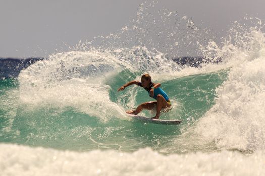 SNAPPER ROCKS, GOLD COAST, AUSTRALIA - 9 MARCH: Unidentified Surfer races the Quiksilver & Roxy Pro World Title Event. 9 March 2013, Snapper Rocks, Gold Coast, Australia