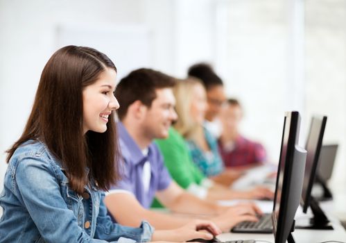 education, technology and internet - students with computers studying at school