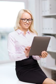 education, business and technology concept - smiling businesswoman or student with tablet pc computer in office