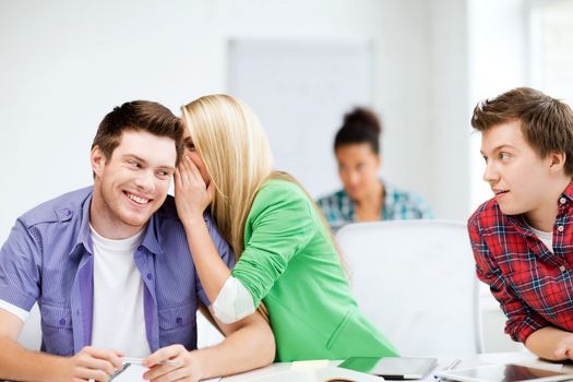 education concept - group of students gossiping at school