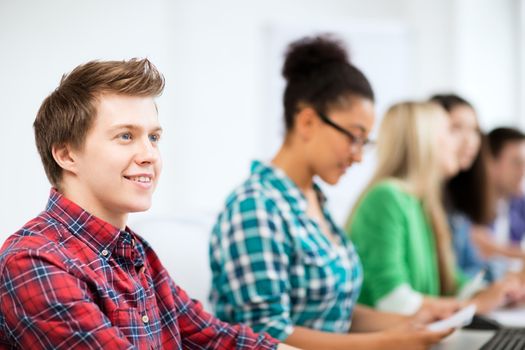 education concept - student with computer studying at school