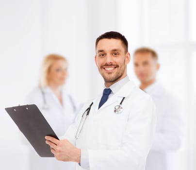 medicine, profession, and healthcare concept - smiling male doctor with clipboard and stethoscope writing prescription over white background