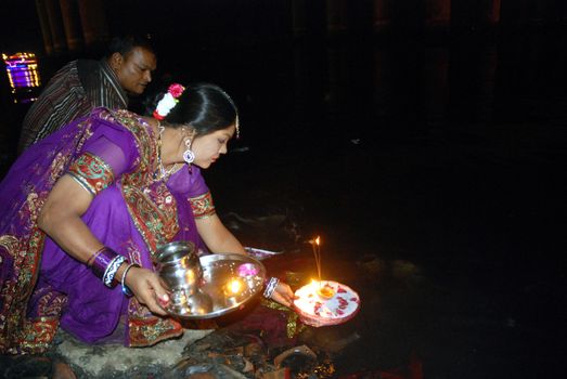 PAKISTAN, Karachi :  A married Hindu woman and her husband light candles at the Netty Jetty temple during the Karva Chauth festival in Karachi on October 30, 2015. Married women observe Karvachauth by fasting and offering prayers seeking welfare, prosperity, and longevity of their husbands.