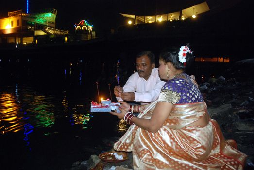 PAKISTAN, Karachi :  A married Hindu woman and her husband light candles at the Netty Jetty temple during the Karva Chauth festival in Karachi on October 30, 2015. Married women observe Karvachauth by fasting and offering prayers seeking welfare, prosperity, and longevity of their husbands.