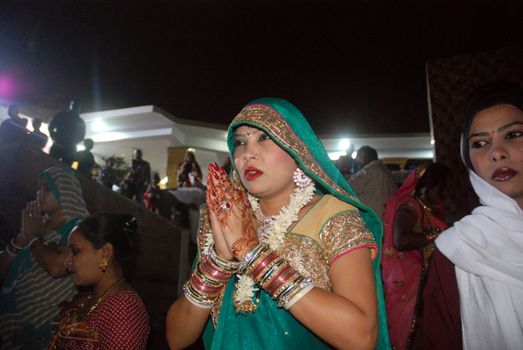 PAKISTAN, Karachi :  A married Hindu woman prays at the Netty Jetty temple during the Karva Chauth festival in Karachi on October 30, 2015. Married women observe Karvachauth by fasting and offering prayers seeking welfare, prosperity, and longevity of their husbands.