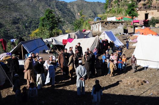 PAKISTAN, Tor Ghar: Pakistani earthquake survivors build tents in Tor Ghar, near Sibi city, on October 28, 2015.  The powerful 7.5-magnitude earthquake that struck on October 26 ripped across Afghanistan and Pakistan, killing nearly 390 people and levelling thousands of homes, forcing many to camp out in the open. The army has led the rescue effort in Pakistan while the government has promised aid and compensation, but with many of the affected communities isolated by rugged terrain, help may not arrive before the snow does. 