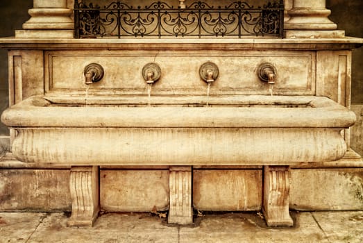 Fountain St. Stephen's in the medieval city  Eger. Hungary. Photo in old color image style.