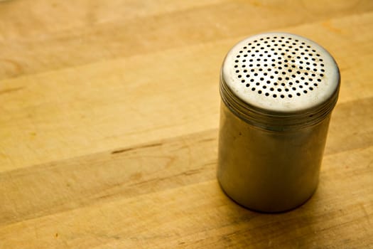 Pepper shaker on a wooden counter