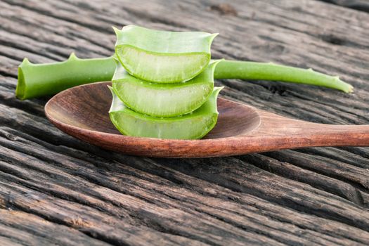 Aloe Vera slice natural spas ingredients for skin care on wooden background.