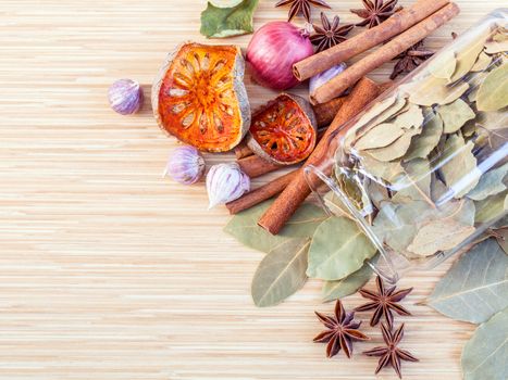 Assortment of Thai food Cooking ingredients in glass bottles on wooden background.