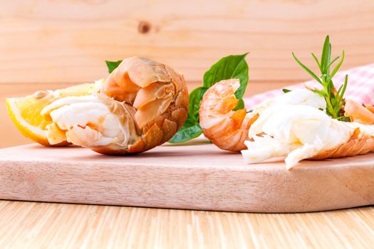 Boiled Flathead lobster, Lobster Moreton Bay bug, Oriental flathead lobster with herbs and spices  sauce on wooden background.