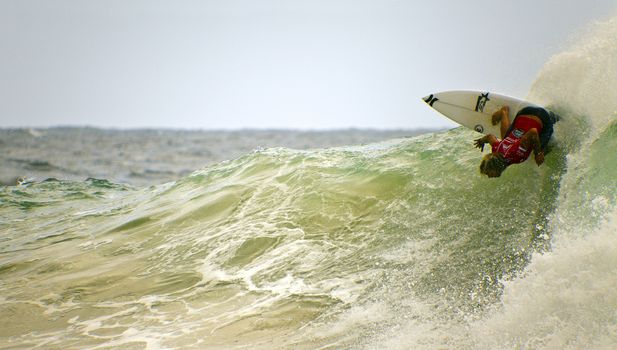 SNAPPER ROCKS, GOLD COAST, AUSTRALIA - FEB 26: Unidentified Surfer races the Quiksilver & Roxy Pro World Title Event. February 26, 2012, Snapper Rocks, Gold Coast, Australia