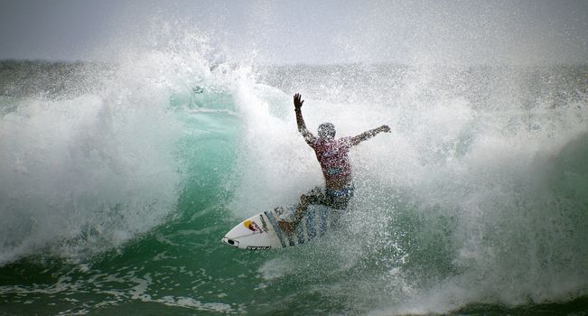 SNAPPER ROCKS, GOLD COAST, AUSTRALIA - FEB 26: Unidentified Surfer races the Quiksilver & Roxy Pro World Title Event. February 26, 2012, Snapper Rocks, Gold Coast, Australia