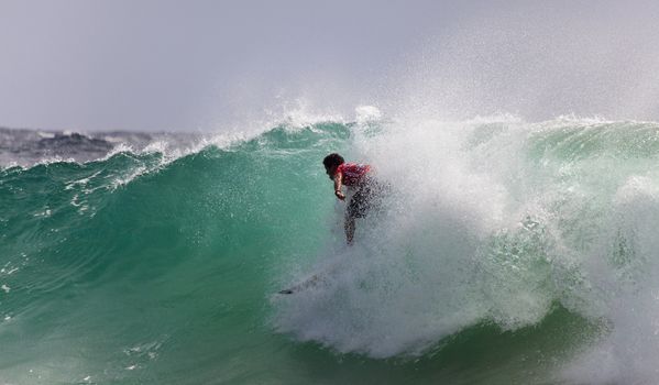 SNAPPER ROCKS, GOLD COAST, AUSTRALIA - FEB 26: Unidentified Surfer races the Quiksilver & Roxy Pro World Title Event. February 26, 2012, Snapper Rocks, Gold Coast, Australia