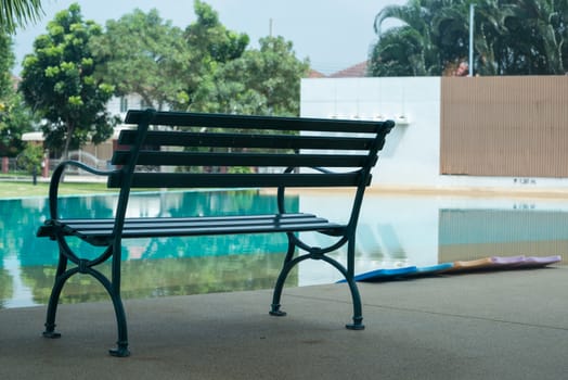 The chair next to the swimming pool.