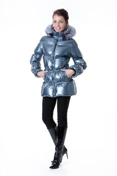 Young beautiful woman in fashionable winter warm clothing on isolated studio background
