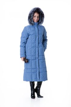Young beautiful woman in fashionable winter warm clothing on isolated studio background