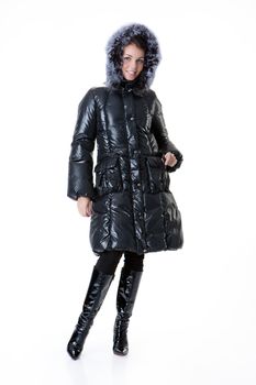 Young beautiful woman in fashionable winter warm clothing on isolated studio background