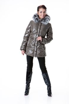 Young beautiful woman in fashionable winter warm clothing on isolated studio background