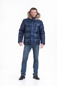 Young man in fashionable winter clothing on isolated studio background