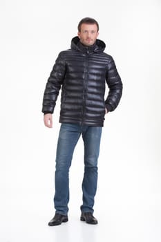 Young man in fashionable winter clothing on isolated studio background