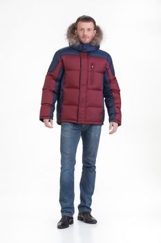Young man in fashionable winter clothing on isolated studio background