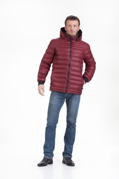 Young man in fashionable winter clothing on isolated studio background