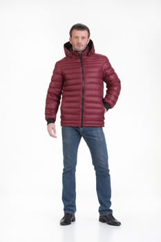 Young man in fashionable winter clothing on isolated studio background