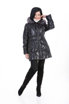 Young beautiful woman in fashionable winter warm clothing on isolated studio background