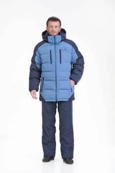 Young man in fashionable winter clothing on isolated studio background