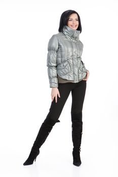 Young beautiful woman in fashionable winter warm clothing on isolated studio background