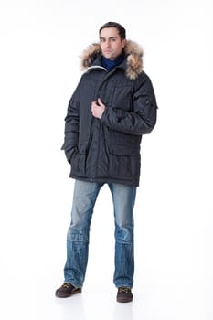 Young man in winter warm clothing on isolated background