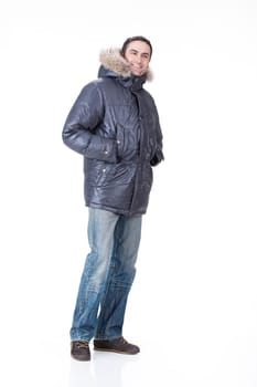 Young man in winter warm clothing on isolated background