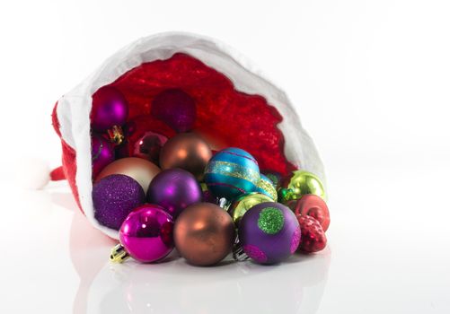 santa hat with christmas balls isolated on white