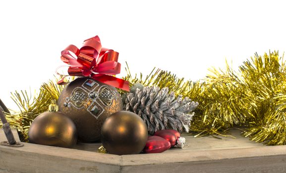 christams balls red bow and golden decoration on wooden plate