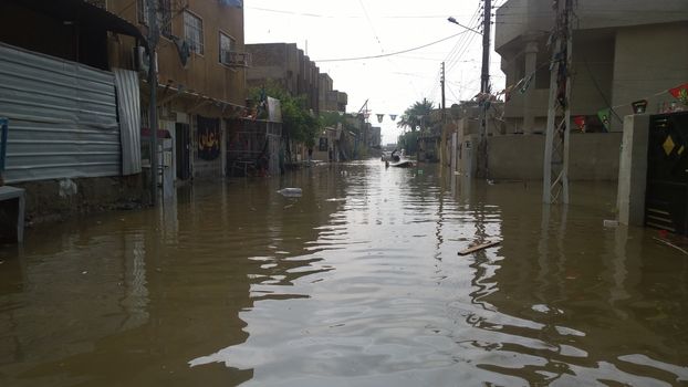  IRAQ, Baghdad : A street of Baghdad, Iraq, under the water after heavy rains on October 29, 2015, resulting a major flooding. According to a spokesman for the meteorological department, more than 2 inches of rain fell on the city in 24 hours. Some motorists were forced to leave their cars when they became stuck in deep water.  	