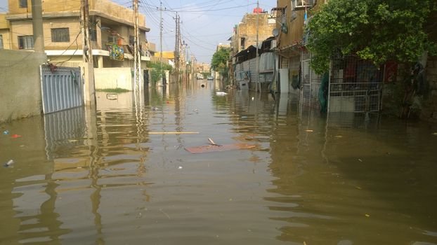  IRAQ, Baghdad : A street of Baghdad, Iraq, under the water after heavy rains on October 29, 2015, resulting a major flooding. According to a spokesman for the meteorological department, more than 2 inches of rain fell on the city in 24 hours. Some motorists were forced to leave their cars when they became stuck in deep water.  	