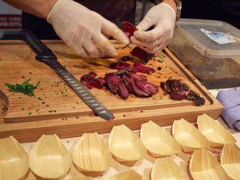 Bison Tenderloin cut into seving slices by a professional chef