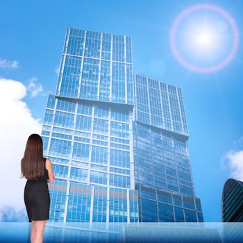 Businesswoman with on cityscape background, rear view