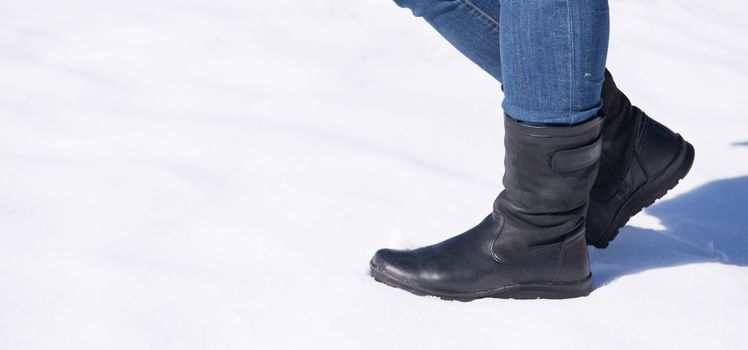 women legs stand on snow