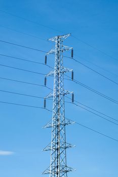 High voltage post or power transmission line tower and blue sky