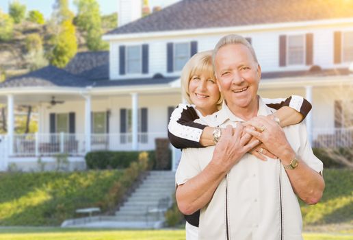 Happy Senior Couple in the Front Yard of Their House.